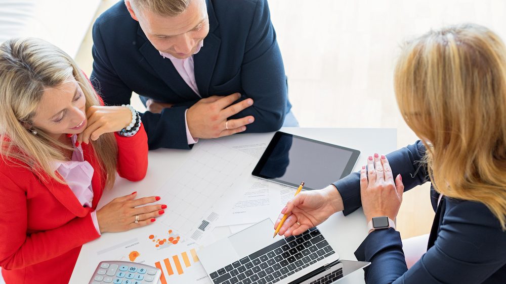 Man and woman getting help from professional financial consultant